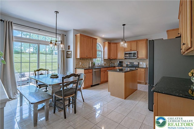 697 Ryan Dr, South Whitehall Twp, PA 18103 - kitchen with stainless steel appliances, decorative backsplash, a kitchen island, light tile patterned floors, and pendant lighting
