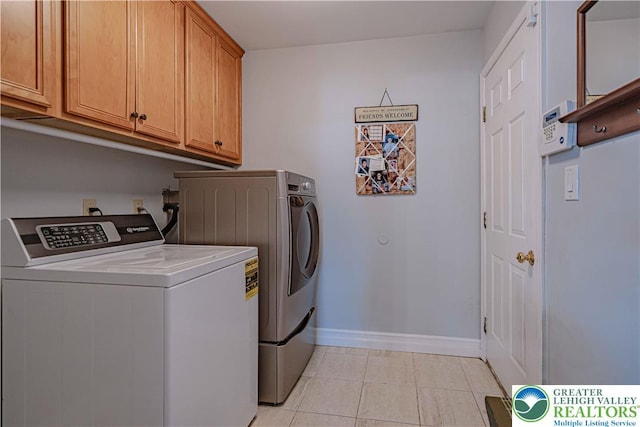 697 Ryan Dr, South Whitehall Twp, PA 18103 - washroom with washer and clothes dryer, cabinet space, baseboards, and light tile patterned floors