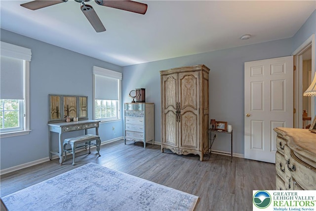 697 Ryan Dr, South Whitehall Twp, PA 18103 - bedroom with multiple windows, baseboards, wood finished floors, and a ceiling fan