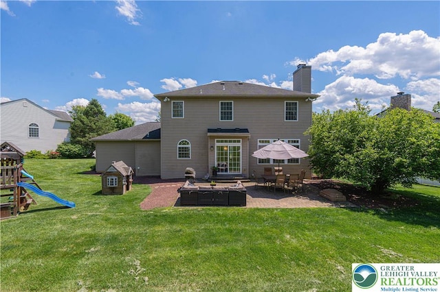 697 Ryan Dr, South Whitehall Twp, PA 18103 - rear view of house with a patio area, a yard, a chimney, and a playground
