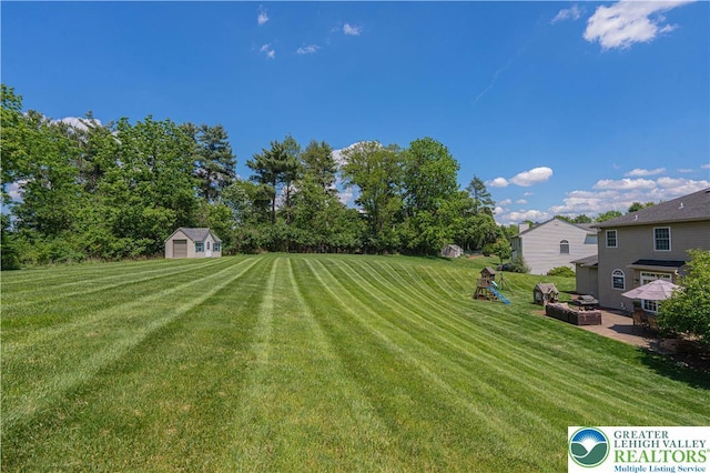 697 Ryan Dr, South Whitehall Twp, PA 18103 - view of green lawn with a patio area