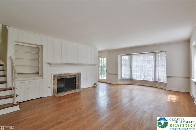 145 N Main St, Allentown City, PA 18104 - unfurnished living room with built in features, wood finished floors, a fireplace, baseboards, and stairway