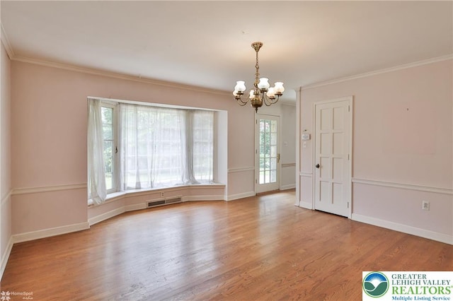 145 N Main St, Allentown City, PA 18104 - spare room with a chandelier, wood finished floors, crown molding, and baseboards
