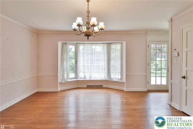 145 N Main St, Allentown City, PA 18104 - unfurnished dining area with wood finished floors, a chandelier, baseboards, and ornamental molding