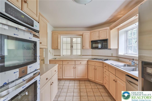 145 N Main St, Allentown City, PA 18104 - kitchen featuring appliances with stainless steel finishes, light brown cabinets, and a sink