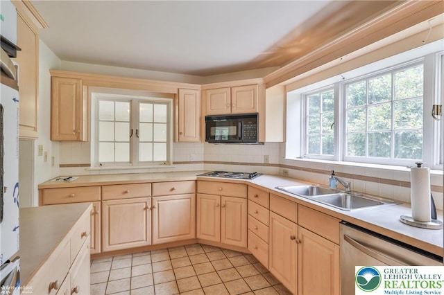 145 N Main St, Allentown City, PA 18104 - kitchen featuring appliances with stainless steel finishes, light brown cabinets, a sink, and decorative backsplash