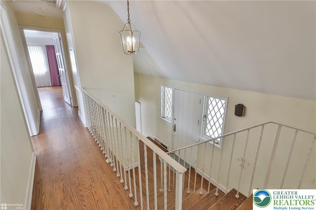 145 N Main St, Allentown City, PA 18104 - stairway featuring plenty of natural light, wood finished floors, vaulted ceiling, and a chandelier