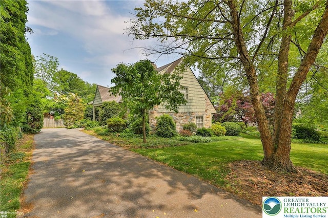 145 N Main St, Allentown City, PA 18104 - view of property exterior with stone siding, a yard, and asphalt driveway