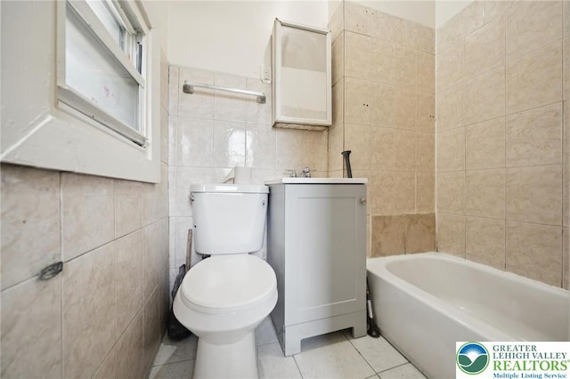 605 N 9th St, Allentown City, PA 18102 - bathroom with tile walls, toilet, tile patterned floors, a tub, and vanity