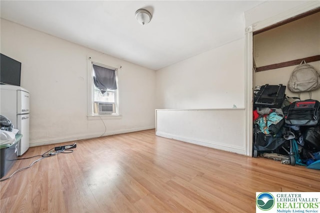 605 N 9th St, Allentown City, PA 18102 - unfurnished bedroom with wood finished floors, cooling unit, baseboards, and freestanding refrigerator