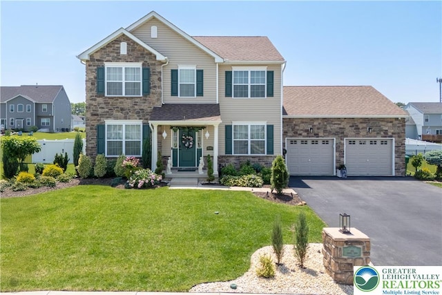 1043 Lisa Ln, Palmer Twp, PA 18045 - view of front of property featuring stone siding, driveway, and a garage