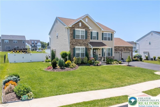 1043 Lisa Ln, Palmer Twp, PA 18045 - view of front of property with stone siding, an attached garage, and driveway