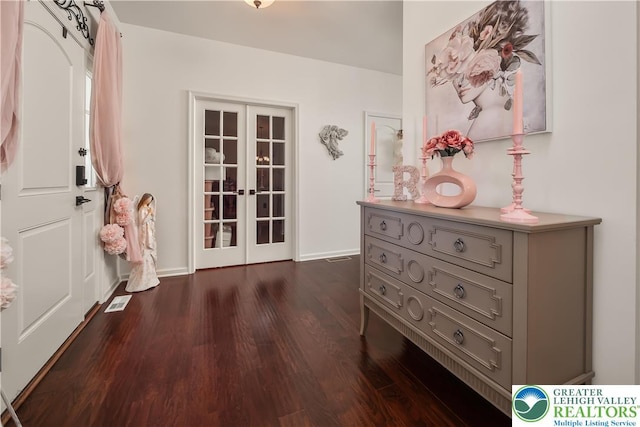 1043 Lisa Ln, Palmer Twp, PA 18045 - entrance foyer featuring french doors, dark wood finished floors, and baseboards