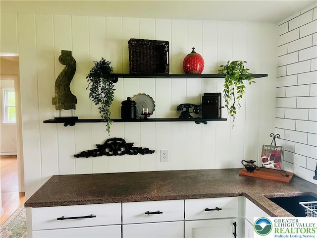 818 W Station Ave, Coopersburg Borough, PA 18036 - kitchen featuring white cabinetry, dark countertops, and wood finished floors
