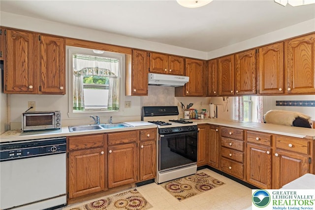 4 Davis St, Luzerne, PA 18706 - kitchen featuring dishwasher, gas range, under cabinet range hood, brown cabinetry, and a sink