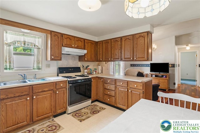 4 Davis St, Luzerne, PA 18706 - kitchen featuring gas range oven, under cabinet range hood, a sink, and plenty of natural light