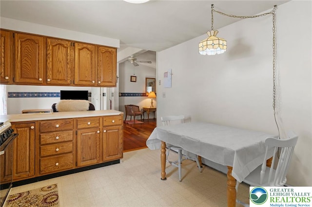 4 Davis St, Luzerne, PA 18706 - kitchen with brown cabinetry, light countertops, hanging light fixtures, and ceiling fan