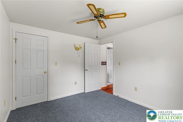 4 Davis St, Luzerne, PA 18706 - unfurnished bedroom with dark carpet, baseboards, and a ceiling fan