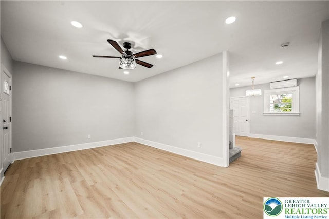 541 Elm St, Emmaus Borough, PA 18049 - spare room with an AC wall unit, recessed lighting, baseboards, ceiling fan, and light wood finished floors