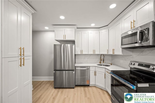 541 Elm St, Emmaus Borough, PA 18049 - kitchen featuring stainless steel appliances, a sink, light wood finished floors, white cabinets, and recessed lighting