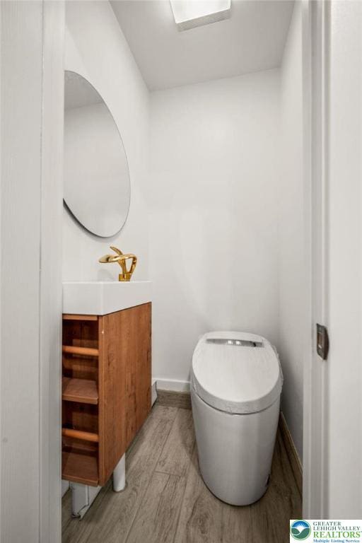 541 Elm St, Emmaus Borough, PA 18049 - bathroom with vanity, wood finished floors, toilet, and baseboards