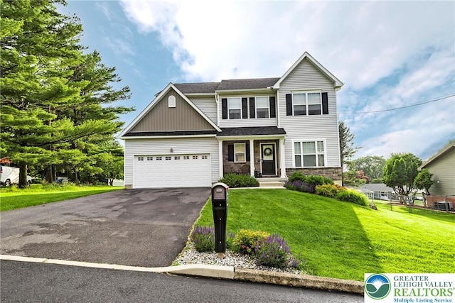 1404 Waverly Ave, Easton, PA 18040 - view of front of house featuring driveway, a front lawn, stone siding, and a garage