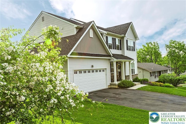 1404 Waverly Ave, Easton, PA 18040 - view of front of home featuring asphalt driveway, a shingled roof, board and batten siding, a garage, and a front yard