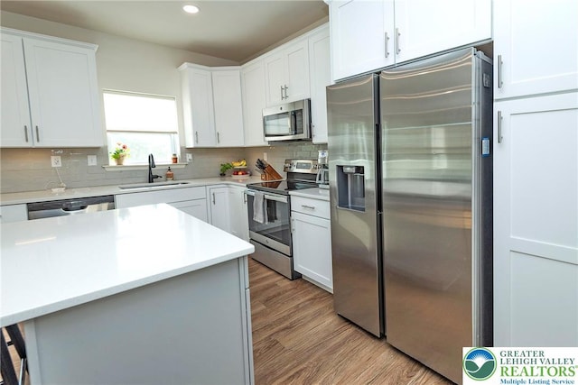 1404 Waverly Ave, Easton, PA 18040 - kitchen with appliances with stainless steel finishes, a sink, wood finished floors, tasteful backsplash, and recessed lighting