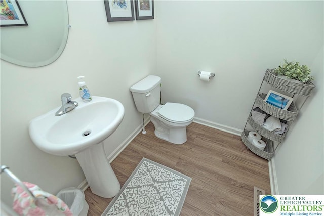 1404 Waverly Ave, Easton, PA 18040 - half bath with toilet, baseboards, wood finished floors, and a sink