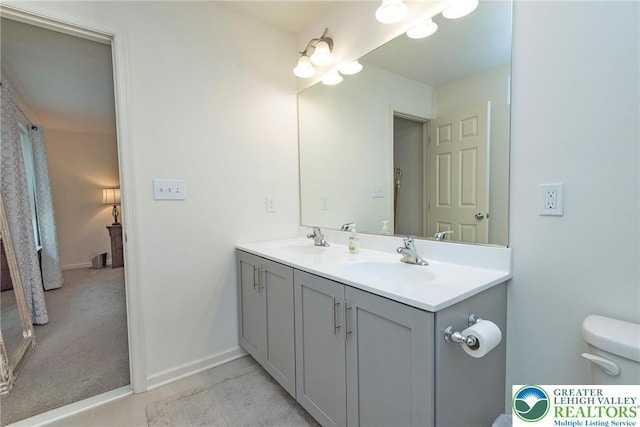 1404 Waverly Ave, Easton, PA 18040 - bathroom with double vanity, toilet, and baseboards