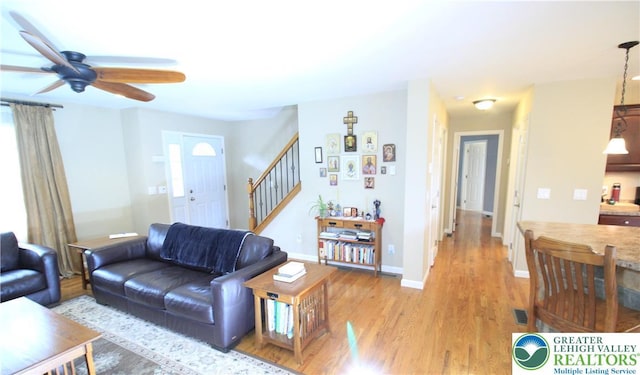 472 Bauer Rd, Moore Twp, PA 18014 - living room with ceiling fan, stairs, light wood finished floors, and baseboards