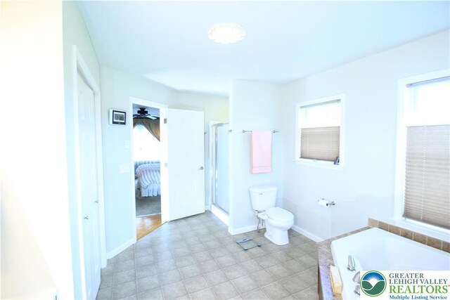 472 Bauer Rd, Moore Twp, PA 18014 - bathroom with toilet, a garden tub, a shower stall, and baseboards
