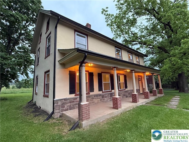 7201 Suter Rd, Coopersburg Borough, PA 18036 - rear view of house featuring stucco siding, a yard, a chimney, and stone siding