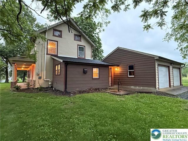 7201 Suter Rd, Coopersburg Borough, PA 18036 - back of property featuring a yard, a garage, and stucco siding