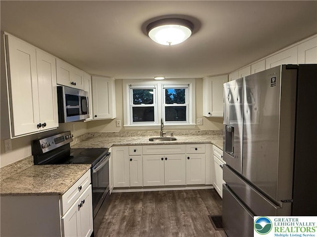 7201 Suter Rd, Coopersburg Borough, PA 18036 - kitchen featuring stainless steel appliances, a sink, dark wood-style floors, white cabinets, and light stone counters