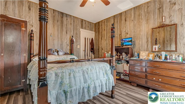 718 Jordan St, Allentown City, PA 18102 - bedroom with wooden walls, wood finished floors, and a ceiling fan