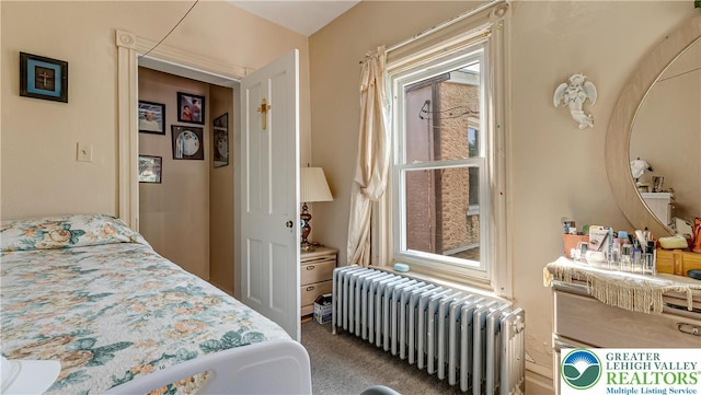 718 Jordan St, Allentown City, PA 18102 - carpeted bedroom featuring radiator heating unit and multiple windows