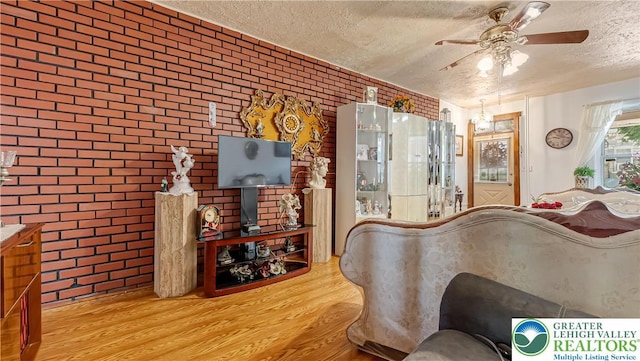 718 Jordan St, Allentown City, PA 18102 - interior space with a textured ceiling, wood finished floors, ceiling fan, and brick wall