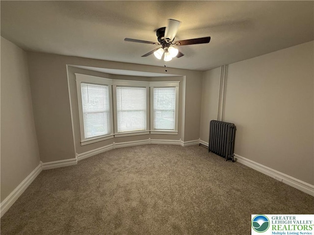 6085 St John St, Allentown City, PA 18103 - empty room with radiator, a ceiling fan, carpet flooring, and baseboards