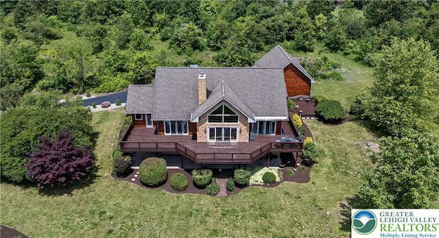 3353 Spring Valley Rd, Washington Twp, PA 18080 - back of house with a chimney, a wooden deck, a lawn, and a view of trees