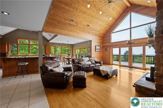 3353 Spring Valley Rd, Washington Twp, PA 18080 - living area featuring high vaulted ceiling, plenty of natural light, wood ceiling, light wood-style floors, and wooden walls