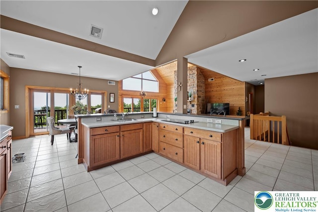 3353 Spring Valley Rd, Washington Twp, PA 18080 - kitchen with a chandelier, wooden walls, open floor plan, plenty of natural light, and black electric stovetop