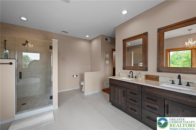 3353 Spring Valley Rd, Washington Twp, PA 18080 - full bathroom with double vanity, a shower stall, a chandelier, toilet, and baseboards