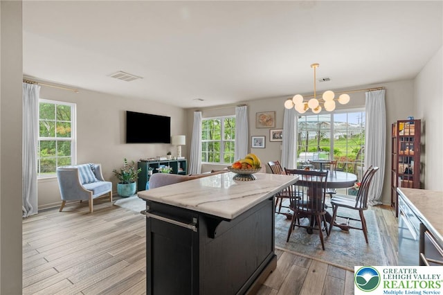 707 Blue Heron Dr, Allentown City, PA 18103 - kitchen featuring a chandelier, healthy amount of natural light, a center island, and light wood-style flooring