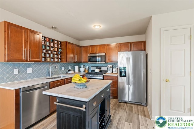 707 Blue Heron Dr, Allentown City, PA 18103 - kitchen featuring appliances with stainless steel finishes, a sink, light wood-style floors, and decorative backsplash