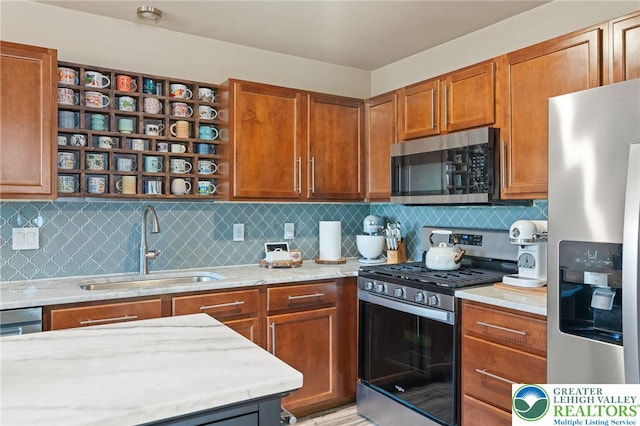 707 Blue Heron Dr, Allentown City, PA 18103 - kitchen featuring appliances with stainless steel finishes, a sink, decorative backsplash, and light stone countertops
