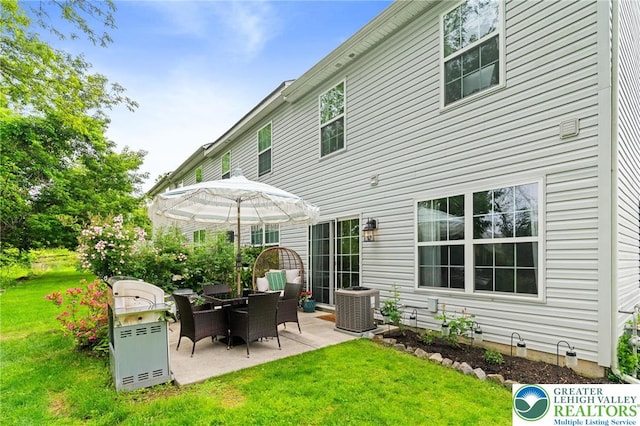 707 Blue Heron Dr, Allentown City, PA 18103 - rear view of house featuring central AC unit, a patio, and a lawn