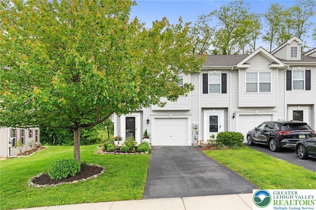 707 Blue Heron Dr, Allentown City, PA 18103 - townhome / multi-family property featuring driveway, a garage, and a front lawn
