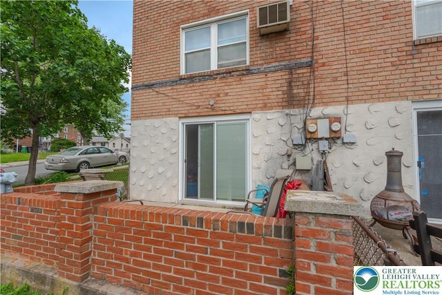 402 Bradford St, Allentown City, PA 18109 - rear view of property with a wall unit AC and brick siding