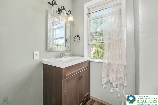 531 E Church St, Slatington Borough, PA 18080 - bathroom with plenty of natural light, vanity, and wood finished floors